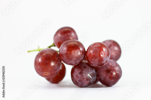 Red grapes on white background.