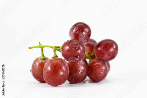 Red grapes on white background.