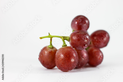 Red grapes on white background.