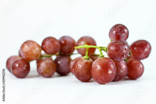 Red grapes on white background.