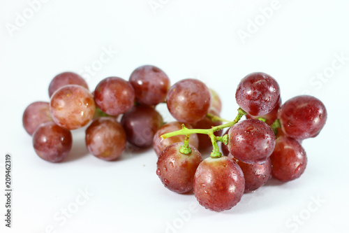 Red grapes on white background.
