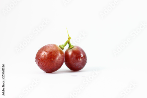 Red grapes on white background.