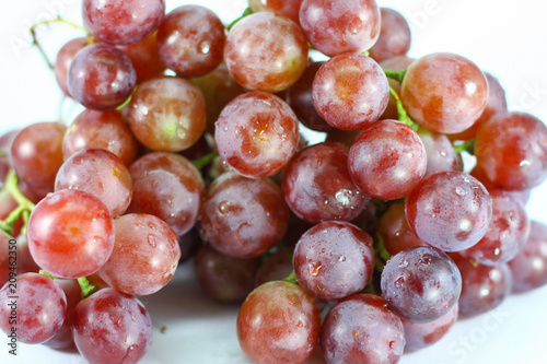 Red grapes on white background.
