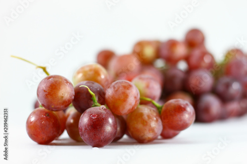 Red grapes on white background.