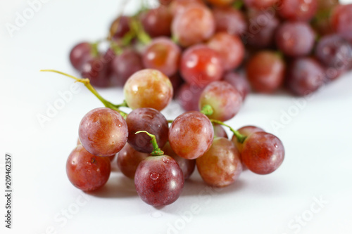 Red grapes on white background.