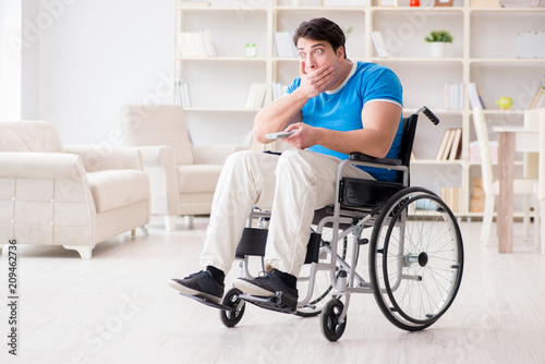 Disabled man watching sports on tv