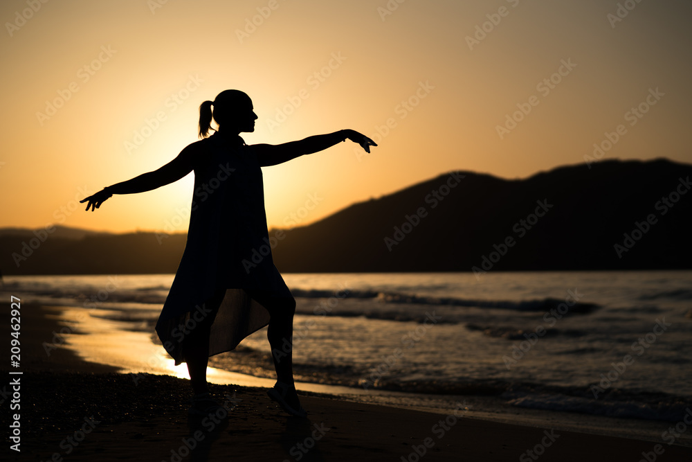 Girl silhouette on the beach