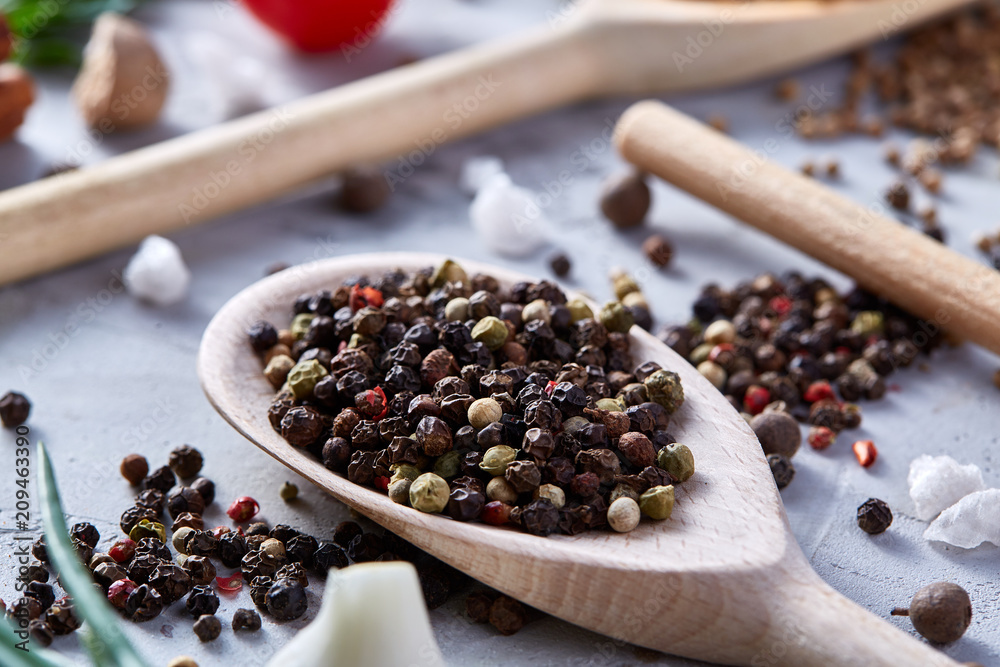 Peppercorns in wooden spoon with clipping path on white textured background, close-up, selective focus. Peppercorns in wooden spoon with clipping path on white textured background, close-up, selective focus.