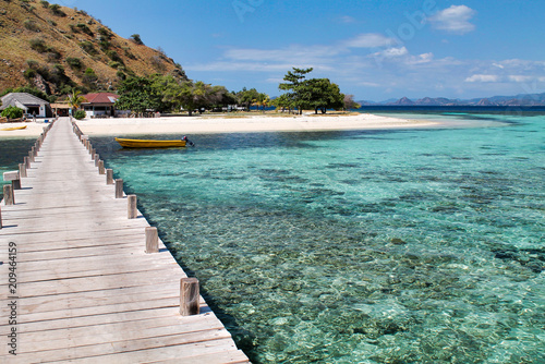 wooden pier and beautiful reef upon arrival in kanawa island