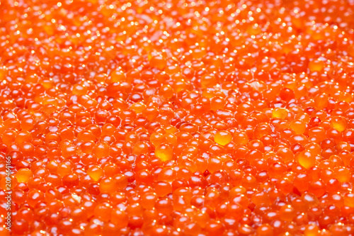 A lot of red caviar. Selective focus.