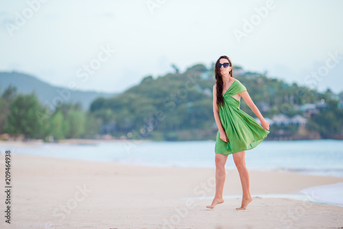 Young beautiful woman having fun on tropical seashore.