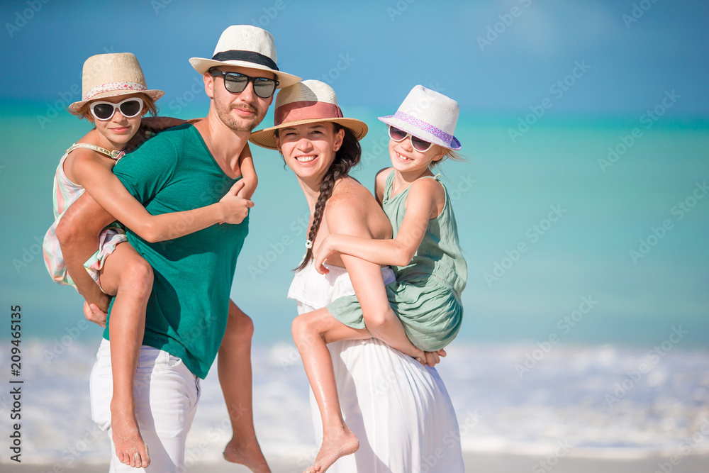 Happy family with kids on the beach together Happy family with kids on the beach together