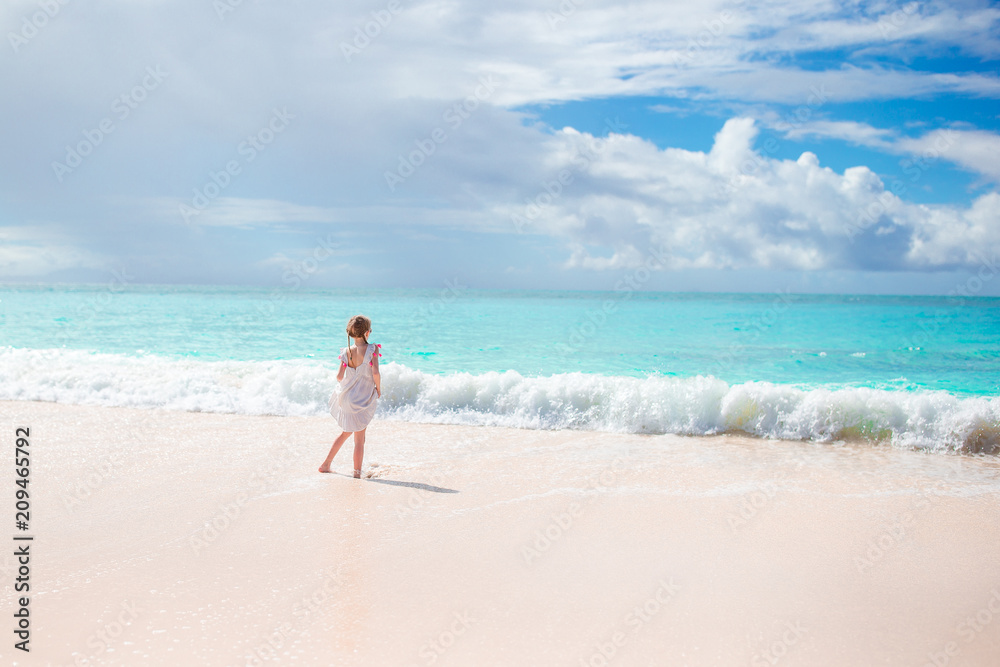 Adorable active little girl at beach during summer vacation Adorable active little girl at beach during summer vacation