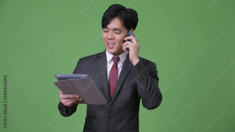 Young handsome Asian businessman using digital tablet Young handsome Asian businessman using digital tablet