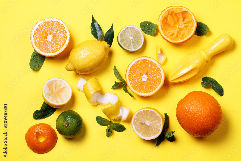 Citrus and juicer on a bright yellow background. View from above Citrus and juicer on a bright yellow background. View from above
