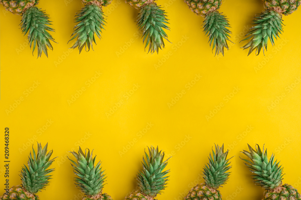 Pineapple Whole tropical fruits with leaves Yellow background Useful Natural organic food Top view Flat Lay Group Objects