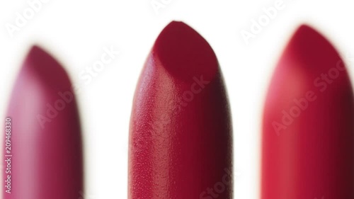 macro shoot of lipstick Three lipstick moving on white background