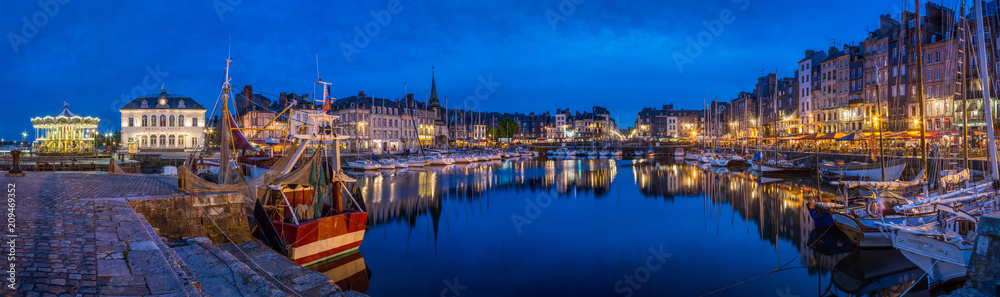 Panoramic view at dusk of the beautiful Honfleur harbour, which offers many fine restaurants overlooking the water