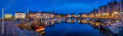 Panoramic view at dusk of the beautiful Honfleur harbour  which offers many fine restaurants overlooking the water