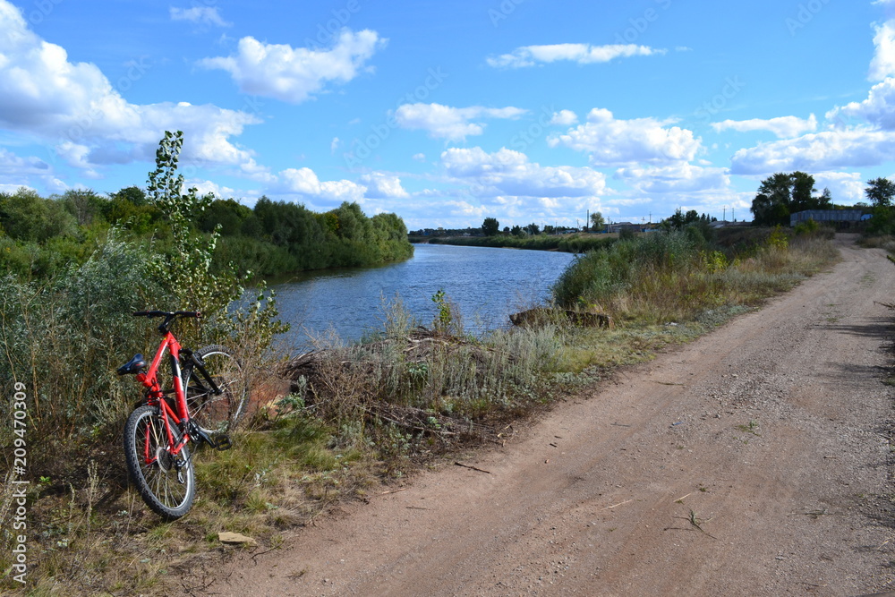 river,road and red bicycle