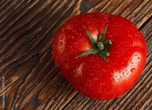 Close-up of fresh, ripe tomatoes on wood background