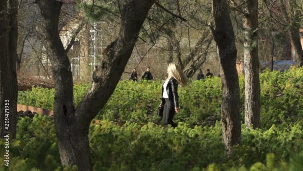 Smiling blond girl is taking a walk Smiling blond girl is taking a walk