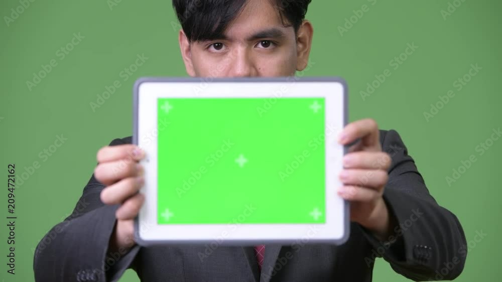 Young handsome Asian businessman using digital tablet Young handsome Asian businessman using digital tablet
