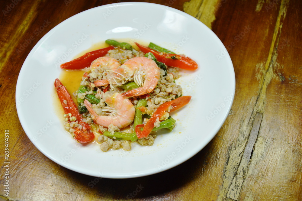 spicy stir fried minced pork and shrimp with basil leaf on plate