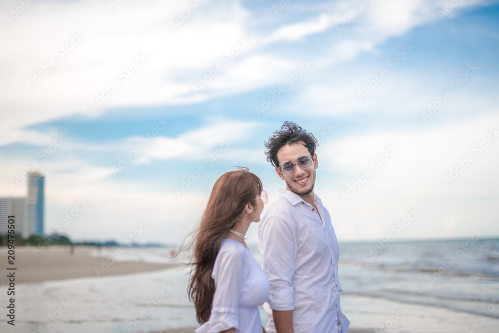 couple in love on beach summer vacations. Joyful girl eye contact on young boyfriend