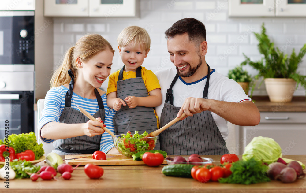 happy family with child preparing vegetable salad happy family with child preparing vegetable salad