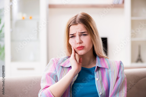 Young woman suffering with pain at home Free Download Young woman suffering with pain at home - GFXLoad