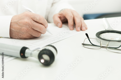 The doctor prescribers, amid Dermatoscope lying on the table