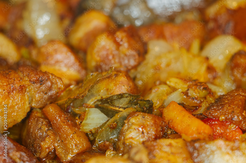 Roast meat, onions, carrots and spices, boiling in oil Roast meat, onions, carrots and spices, boiling in oil