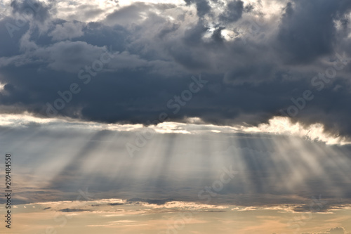 Dramatic sky with clouds and sun rays. © ekim