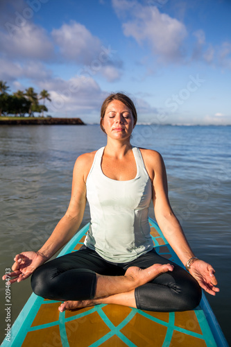 Pretty young woman in meditation on the water at Ala Moana state park Oahu Hawaii © Deborah Kolb