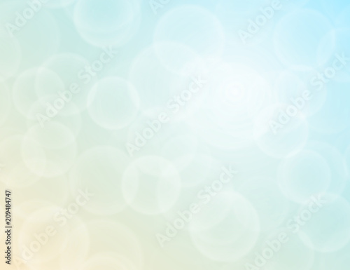 Vector bokeh texture on a bright two-tone blue-yellow background. Festive abstract blur background.