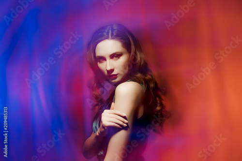 Portrait of beautiful girl on blue and red background