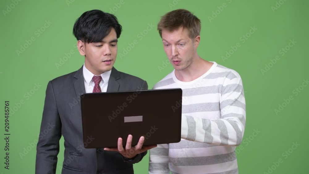 Young handsome Asian businessman and young Scandinavian businessman working together Young handsome Asian businessman and young Scandinavian businessman working together