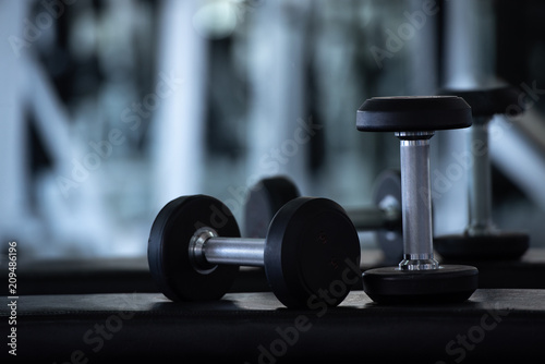 Fototapeta Naklejka Na Ścianę i Meble -  Close up of modern dumbbells equipment in the sport gym , gym equipment concept.