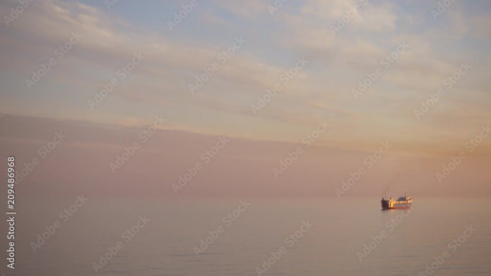One big ocean ship in the sea at beautiful sunset. One big ocean ship in the sea at beautiful sunset.