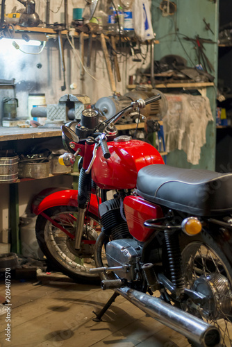 Red vintage motorcycle parked in the garage