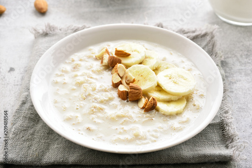 Oatmeal porridge with banana slices and nuts