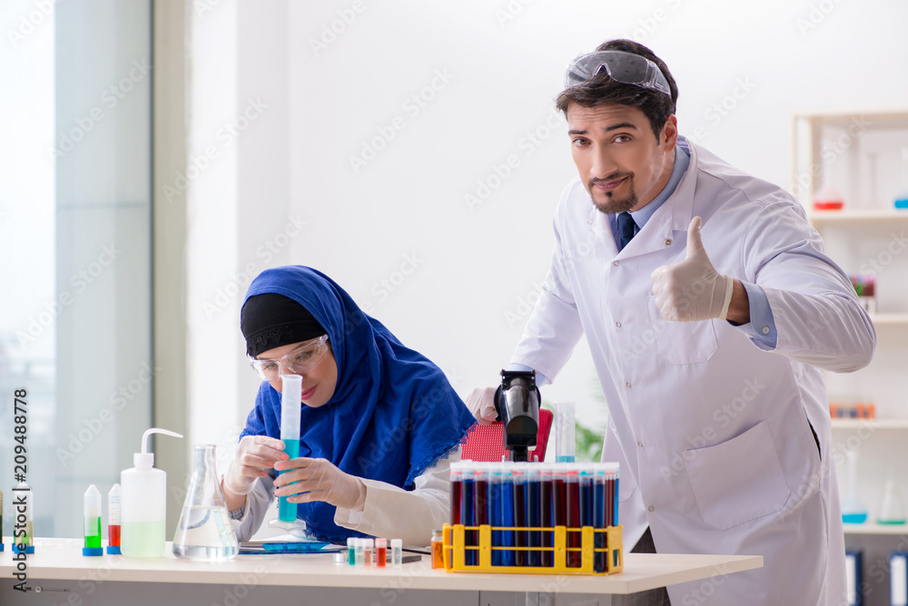 Two chemists working in the lab Two chemists working in the lab
