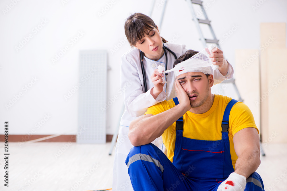 Worker with injured head and doctor