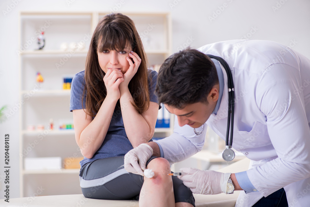 Fototapeta premium Patient visiting doctor after sustaining sports injury