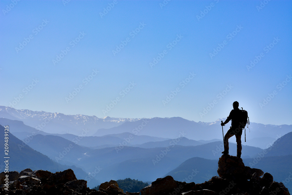 successful people at the height of desolate and fascinating mountains