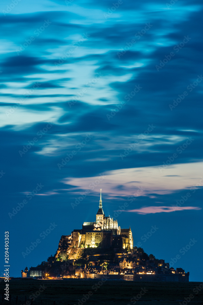 Mont St Michel Abbey illuminated at dusk in Normandy