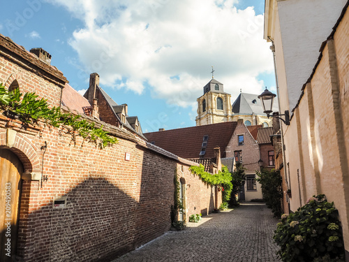 Cobblestone streetleading to the beguinage church in the large beguinage in Mechelen, Belgium photo