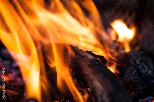 Extreme closeup of open fire flames. Barbecue fire preparing in the outdoors. Blurred fire flames in abstract image. Burning wood in extreme closeup view.