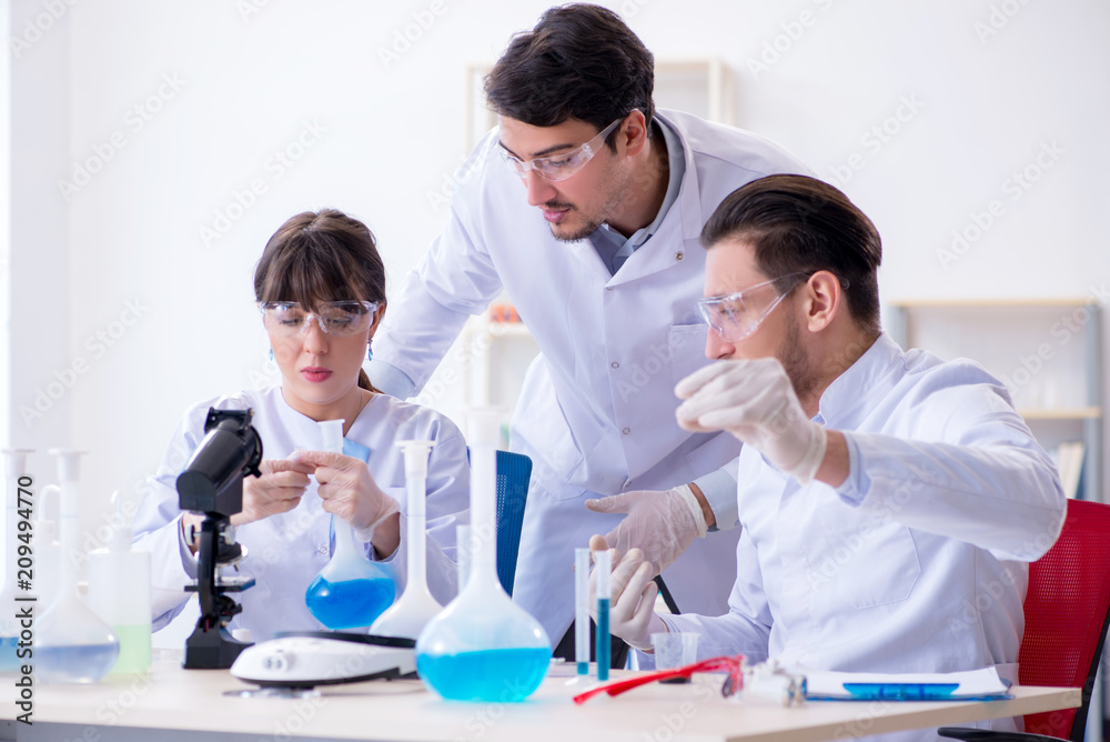 Team of chemists working in the lab Team of chemists working in the lab